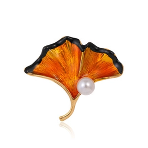 Macro detail of ginkgo leaf brooch with orange gradient enamel and pearl accent