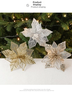 Macro detail of glittered mesh Christmas flowers in gold and silver on a festive tree