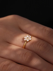 Macro view of 18k gold plated flower ring featuring six pear-shaped cubic zirconia petals