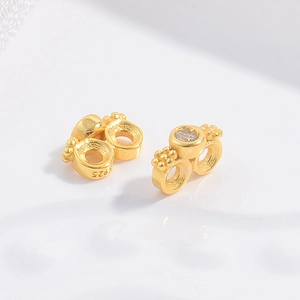 Macro shot of S925 sterling silver gold-plated spacers with micro-set zircon for DIY jewelry