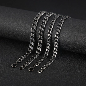 Detail of four stainless steel cuban link chains in different widths with lobster clasps