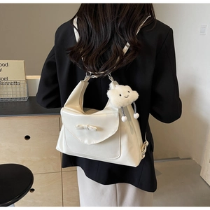 Detail of white PU leather backpack featuring a 3D bow and cute plush cloud charm