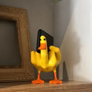 Macro detail of the yellow resin duck figurine holding a smartphone on a desk