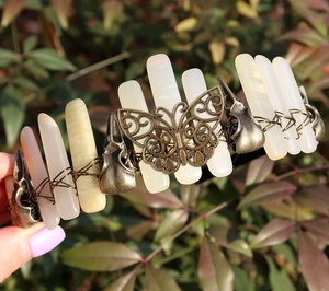 Close-up of vintage bronze headband featuring natural crystals, butterfly and skull motifs