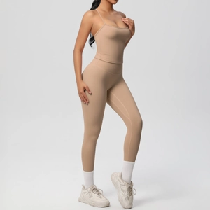 Detail of high-waist seamless yoga leggings and strappy tank top in light brown