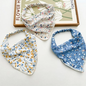 Detailed close-up of floral headscarves with lace trim and elastic hair ties