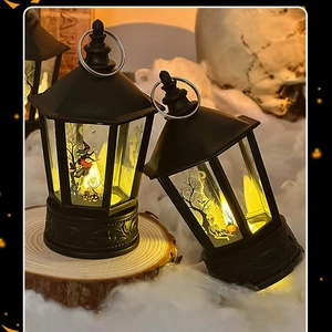Close-up of Halloween LED lanterns with witch and skeleton silhouettes on rustic wood