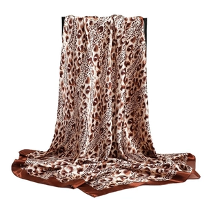 Luxurious leopard print satin scarf with brown border for women elegantly draped