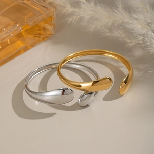 Minimalist teardrop open bangles in polished gold and silver stainless steel finish