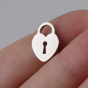 Detailed macro shot of a mini heart-shaped lock pendant in polished stainless steel