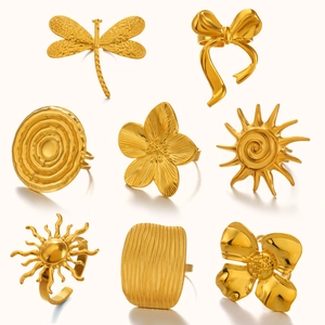Set of eight gold stainless steel open rings with dragonfly, floral and geometric shapes
