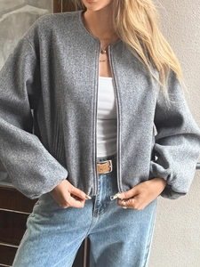 Detail of grey short zip-up wool blend jacket with dropped shoulders for casual styling