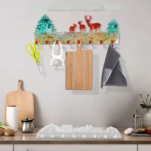 Detail of Christmas elk and pine tree silicone mold for DIY resin wall hooks with gold leaf