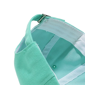 Detail of mint green cotton baseball cap showing silver metal buckle and clean stitching