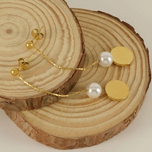 18K gold plated tassel titanium steel earrings with white pearls on wooden display