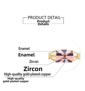 Macro detail of gold-plated enamel pendant with red heart zircon and pave settings