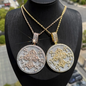 Close-up of hip-hop shield necklaces featuring zircon fleur-de-lis cross pendants on chains