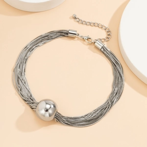 Detailed shot of silver multi-layer punk chain necklace with smooth spherical metal pendant