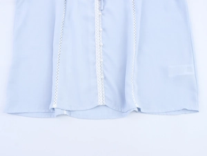 Detail of light blue chiffon top with white lace trim and elegant pearl buttons