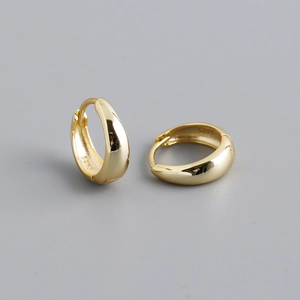 Detailed macro view of S925 hallmark on the inner band of these gold hoop earrings