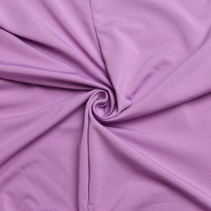 Macro shot of purple knitted fabric showing smooth texture and drapes in a spiral pattern