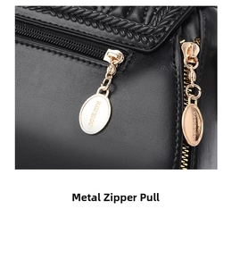 Detailed shot of the gold-tone metal zipper pull on the black textured leather handbag