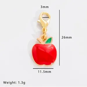 Detail of red apple alloy pendant with gold lobster clasp and 26mm x 11.5mm size specs