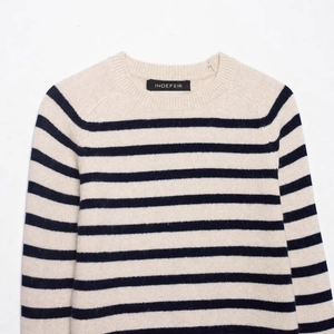 Classic crewneck striped knit sweater in cream white and dark blue with soft texture