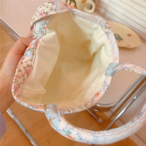 Close-up of the spacious interior and floral patchwork design of this cotton tote bag