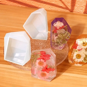 Detail of geometric diamond silicone molds with dried flower resin casting samples