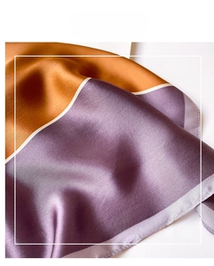 Detail of silk scarf showing caramel and purple satin texture with smooth silky feel