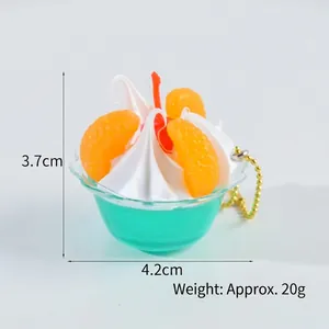 Miniature fake ice cream sundae charm with orange fruit slice and gold ball chain