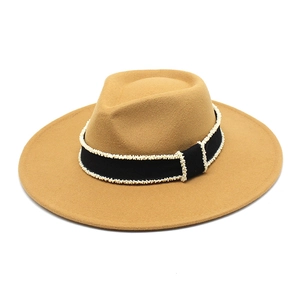Detail of wool fedora hat with black ribbon and miniature pearl bead embellishments