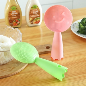 Standing non-stick rice paddle set with smiley face design in green and pink colors