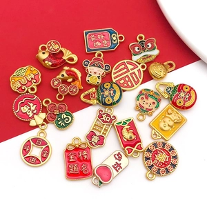Collection of traditional gold Chinese New Year charms featuring koi fish and lion dance motifs
