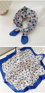 Floral cotton linen scarf detail with navy blue edges and delicate colorful blossom prints