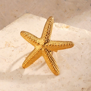 Exaggerated gold starfish ring with realistic bio-inspired texture and open band design
