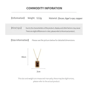 Macro detail of square tiger eye stone pendant showing zircon inlay and gold plating finish