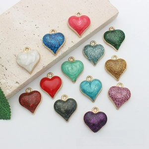 Macro detail of heart-shaped alloy pendants with gold trim and marble texture