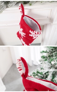 Detailed view of red and white plush Christmas stocking with snowflake patterns