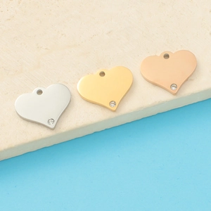 Three mirror-polished heart pendants in silver gold and rose gold with tiny diamonds