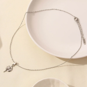 Macro shot of silver stainless steel crescent moon pendant necklace with star motif detail