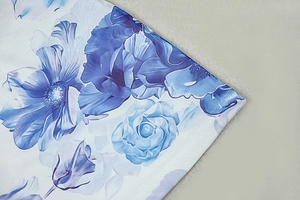 Detailed close-up showing the blue floral print and woven cotton texture of the dress