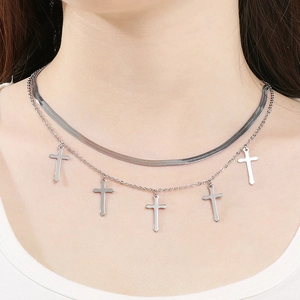 Close-up of double layer silver stainless steel cross pendant necklace on a model