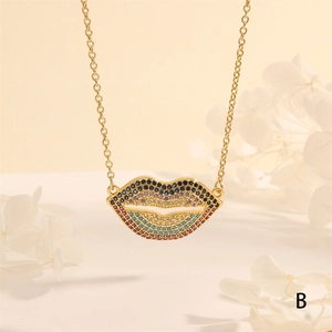 Close-up of a sexy lip pendant necklace with colorful cubic zirconia on a gold chain