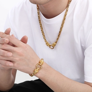 Men's punk gold dragon head chain necklace and bracelet set worn on a white t-shirt