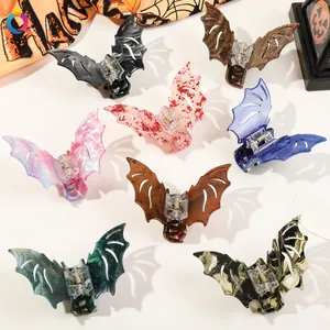 Macro detail showing eight colorful bat-shaped hair claws for Halloween themed styling