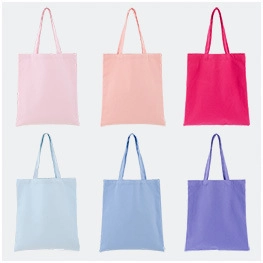 Collection of colorful drawstring canvas tote bags in pink, blue, and purple finishes