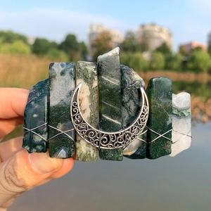 Detail of handmade 8cm boho moon hair clip with green and white raw crystals