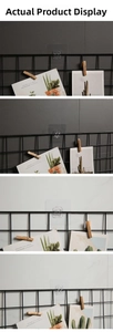 Close-up of transparent adhesive wall hooks securing a black metal wire storage rack